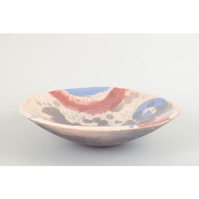 European Studio Potter Large ceramic bowl, 1980s. Wheel-thrown bowl with abstract decoration in red, blue, and grey tones...