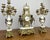 A magnificent antique louis xv garniture set featuring an elegant mantle clock with its matching pair of original...
