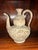 This vessel is a 15th century ceramonial Thai ewer with incised carp eating water lilly's culturally associated with...