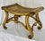 A wood and rattan painted bench. The finish with an applied antique patina and gilded highlights. Retains the original...