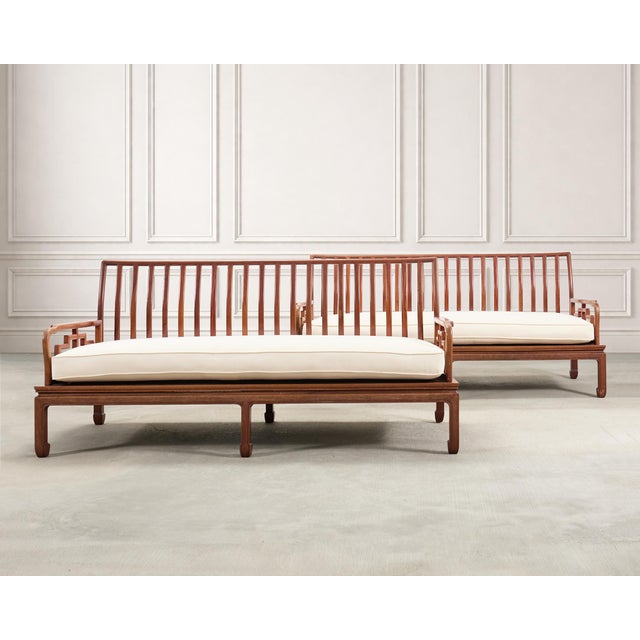 A finely crafted pair of Chinese export Ming Dynasty-style hardwood sofa benches crafted in the manner and style of...