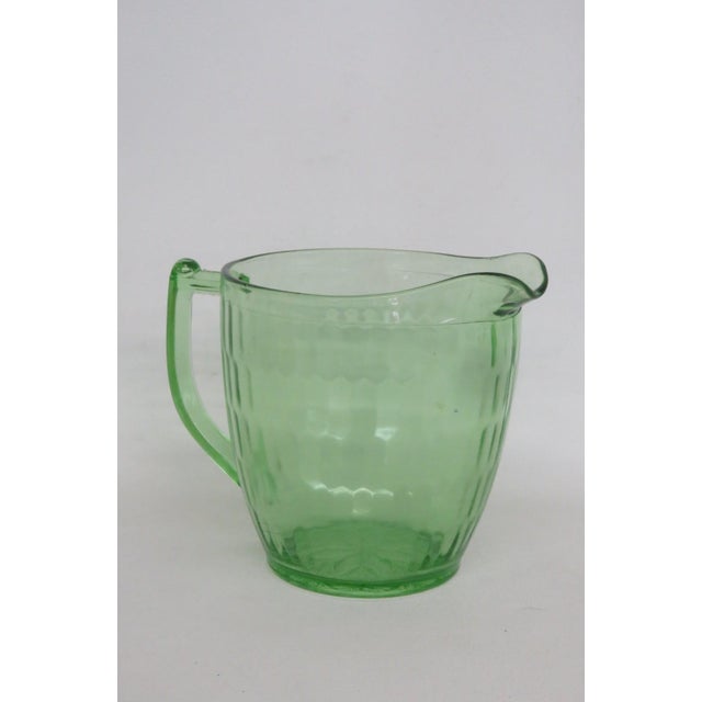 This gorgeous round Pitcher is made of depression-era glass. This Pitcher has a lovely vintage design consisting of a...