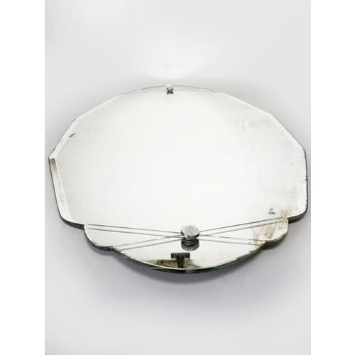 Elegant Art Deco wall mirror dating from the 1940s. Its geometric silhouette with soft lines is enhanced by beveled edges...