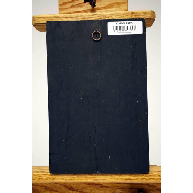 In this art work the artist portrays Moses holding the Ten Commandments by overlaying sheets of metal on top of each...