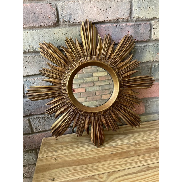 A gorgeous classic 18" warm golden Sunburst Wall Mirror from the 1990s-2000. This composite resin mirror replicating...