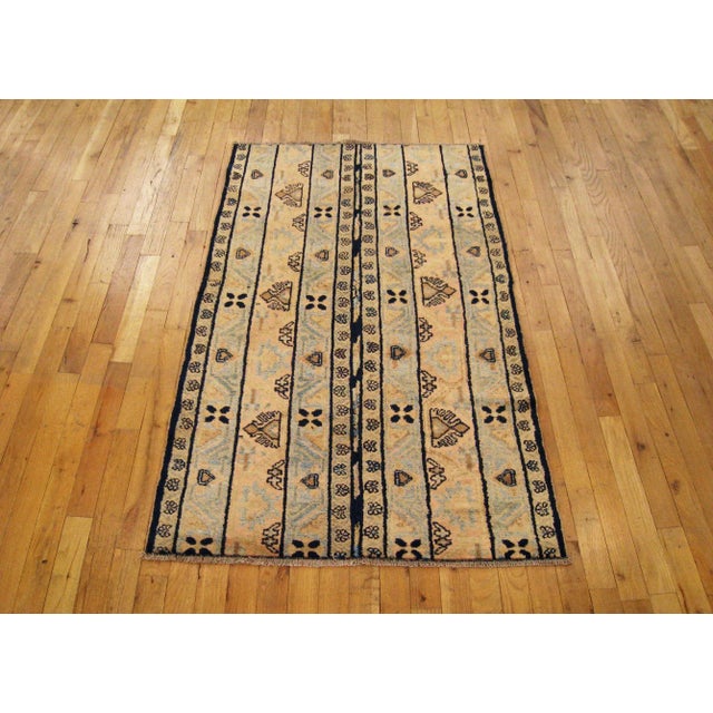 A antique Persian N.W Persia Rug, 4' 7" H x 2' 9" W, circa 1900. The short wool pile is even throughout, with even wear,...