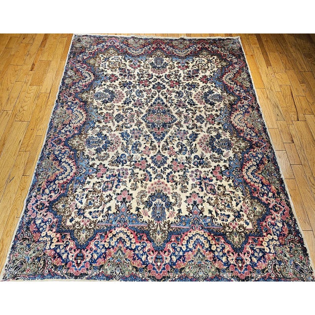 "Step into timeless elegance with this vintage Persian Kerman Lavar rug, a room-size masterpiece from the early 1900s....