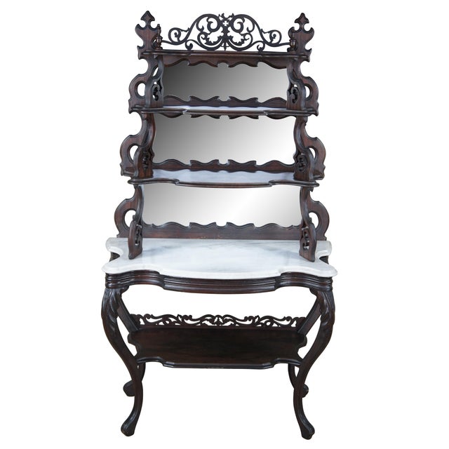 Antique Victorian tiered etagere display shelf / library bookshelf / parlor console. Made of Rosewood featuring serpentine...