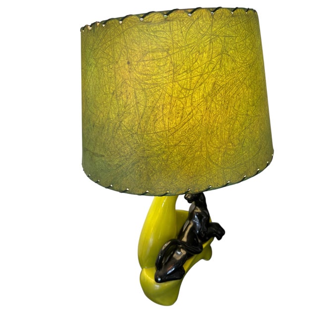 Very cool 1950s table lamp featuring Black ceramic pan against the green chartreuse base. The base creates this fluid open...