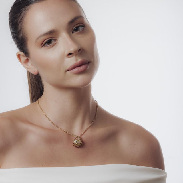 This vintage necklace from the 1980’s is crafted with a pendant in 18k yellow gold suspended from a 14k yellow gold chain....