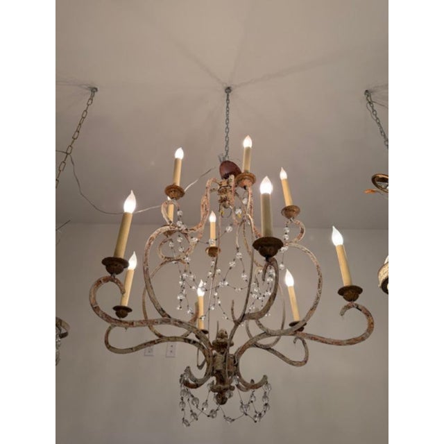 This is a Niermann Weeks Avignon chandelier with 12 arms in a rust and clay like finish. This piece takes 12 candelabrum...