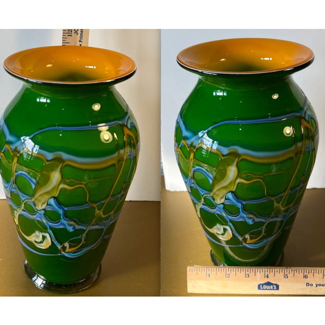 This 11 + inches tall hand blown Azerbaijani Art Glass Vase is a captivating testament to artistic skill. Its emerald...