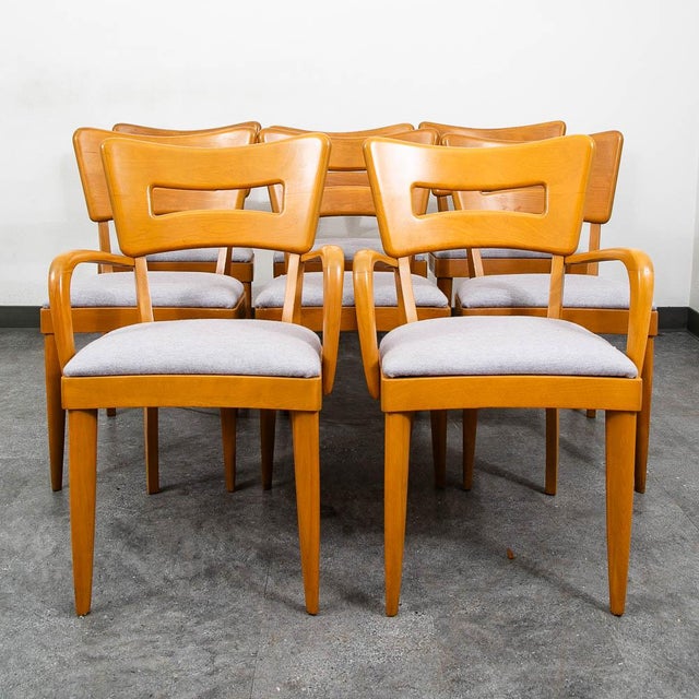 Handsome set of 8 "dog bone" dining chairs in solid birch by Heywood Wakefield. The fabric and seats have been...