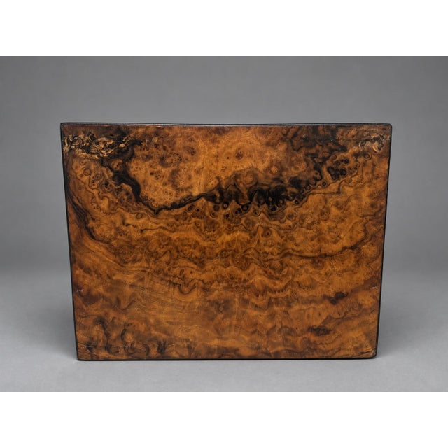 An English table cabinet, dating to the second half of the 19th century, veneered in richly figured burr walnut and fitted...