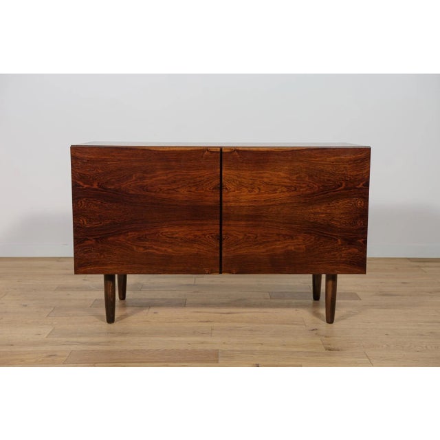 A sideboard designed by the Danish designer Ib Kofod-Larsen, produced in the 1960s in the Danish factory Faarup...