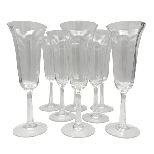 Elegant set of eight Lenox “Allure” champagne flutes in clear lead crystal with a gently flared bowl and faceted stem....