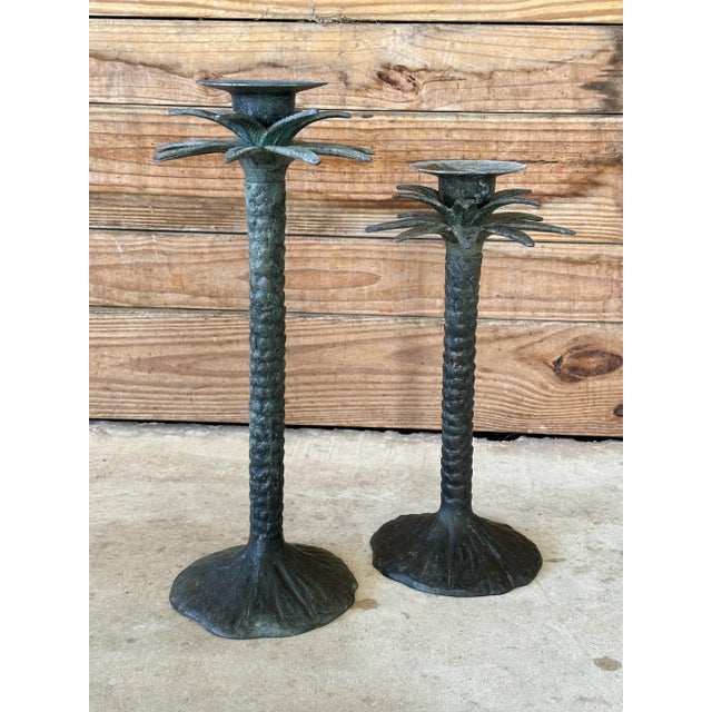 Pair of vintage rustic metal Palm tree candlestick holders with a patinated verdigris finish for a coastal rustic style....