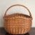 A real beauty, this rustic mid-20th century market basket features intricate handwoven designs, a braided rim, and French...