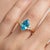 This elegant ring showcases a striking Blue Topaz gemstone, admired for its vivid sky-blue hue and exceptional brilliance....