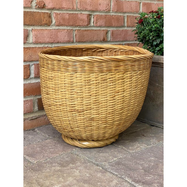 Large hand woven wicker basket / planter sits on a 1” twisted circular pedestal base. Meticulously woven. Sturdy and large...
