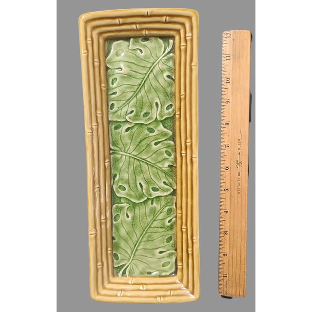 Delight your guests with a touch of exotic elegance using this ceramic tray platter, adorned with a lush tropical bamboo...
