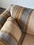 Wrapped entirely in richly textured striped upholstery, this vintage sofa carries a low, architectural silhouette with a...