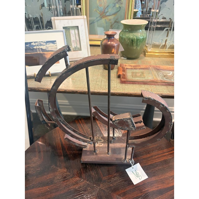 Signed welded steel sculpture by California artist Frank Cota. A dynamic composition of intersecting circular forms and...