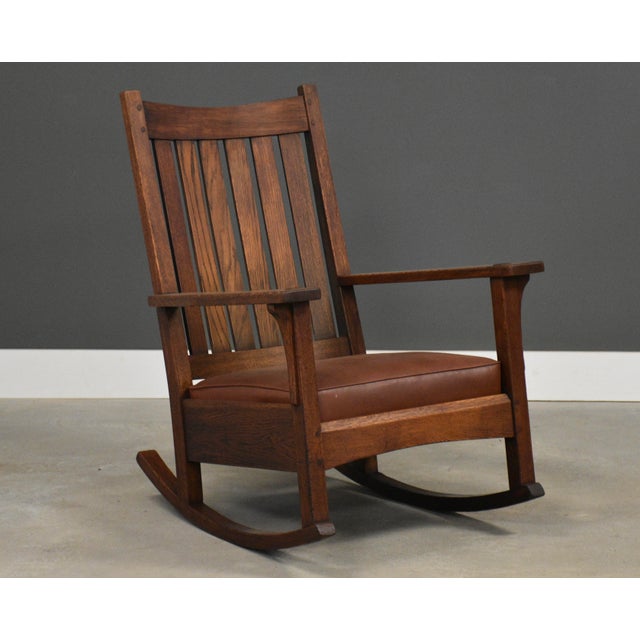 This handsome L. & J.G. Stickley Mission oak rocking chair showcases the clean lines and exceptional craftsmanship that...