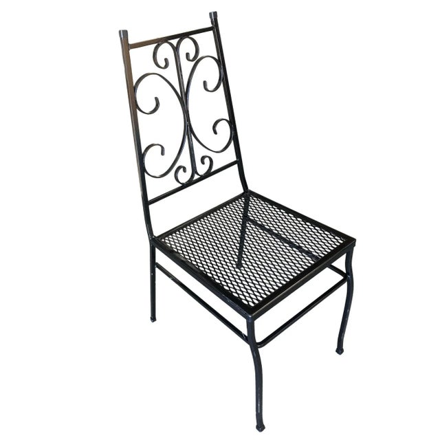 Set of four outdoor patio chairs with scrolling pattern and mesh steel seats. Please inquire us if you would like a...