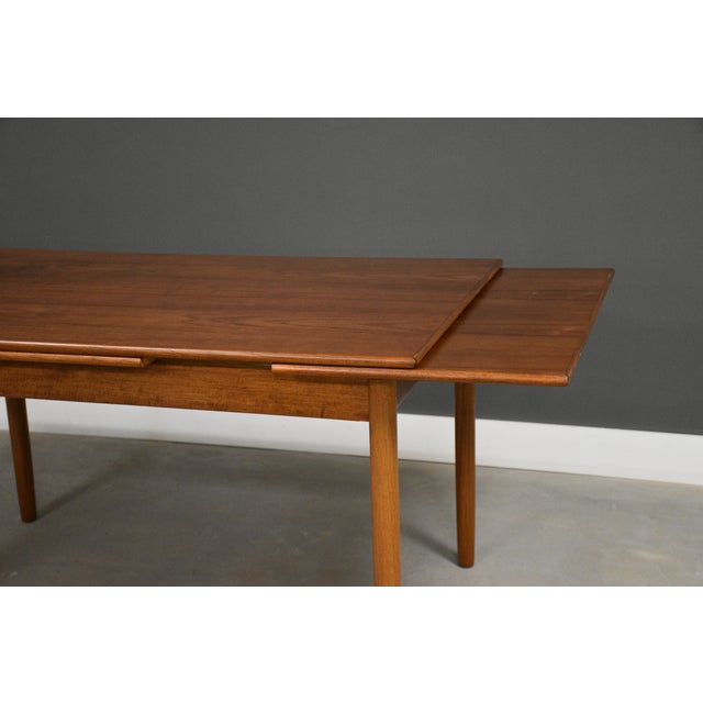 A mid century modern teak draw leaf dining table with two self storing leaves. Made in Denmark. Professionally refinished....