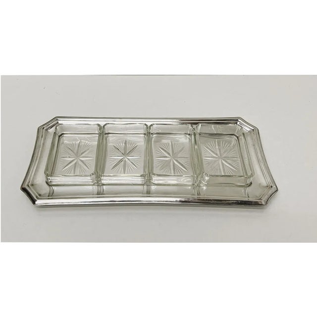 A silver plate dish with 4 rectangular cut glass trays. marked krupp berndorf epns - please see picture. the plate and...