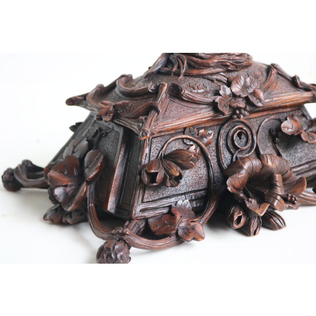 A true work of art, this stunning 19th-century Black Forest jewelry box from Switzerland is fully hand-carved and a...