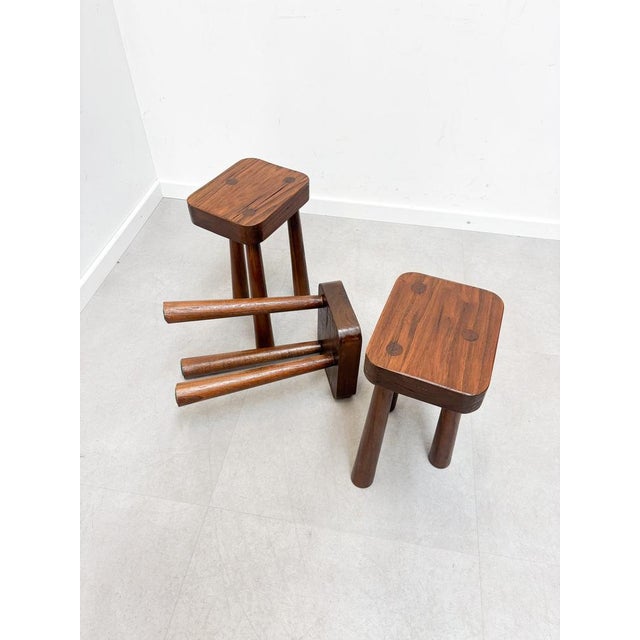Raw and timeless, these brutalist stools are crafted from solid elm wood. with their thick square seats featuring visible...