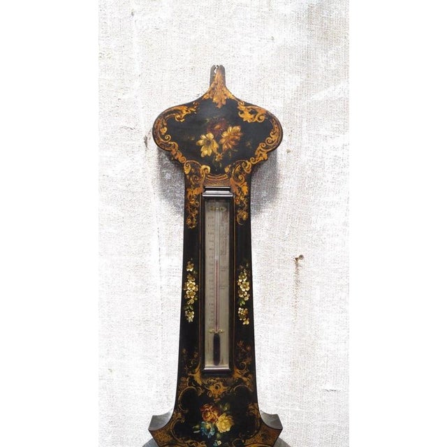 The elegant mahogany case houses the traditional meteorological instruments associated with high-quality 19th-century...