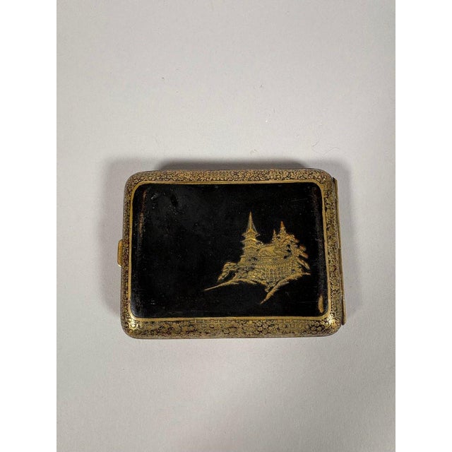 Japanese cigarette case, Meiji era, early 20th century. The case is made of lacquered steel inlaid with gold. One side...