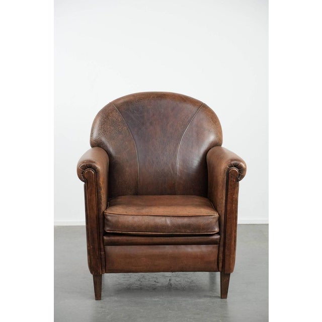 Beautiful vintage sheepskin armchair with warm colors and a characterful appearance. : This characterful sheepskin...