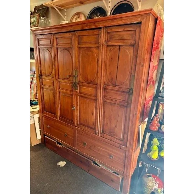 This stunning Chinese Cabinet in its natural Elm wood finish with brass hardware is a great storage piece. The interiors...