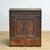 Japanese cabinet from the early 20th century, crafted from wood with a warm dark brown finish. This compact piece of...