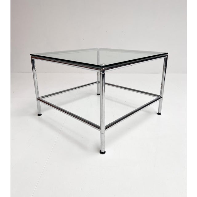 Chrome coffee table with tempered glass (see hallmark on table, 10 mm). The tabletop is held in place by the knobs on the...