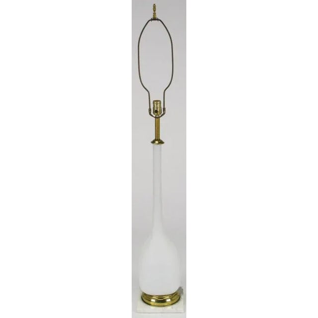 Matte white long neck vase shaped handblown Murano glass bodied table lamp. Two part base is comprised of a stepped brass...