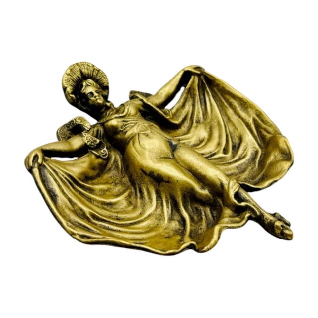 An elegant Art Nouveau decorative object with sculptural character This vintage vide-poche in gilt brass features a...
