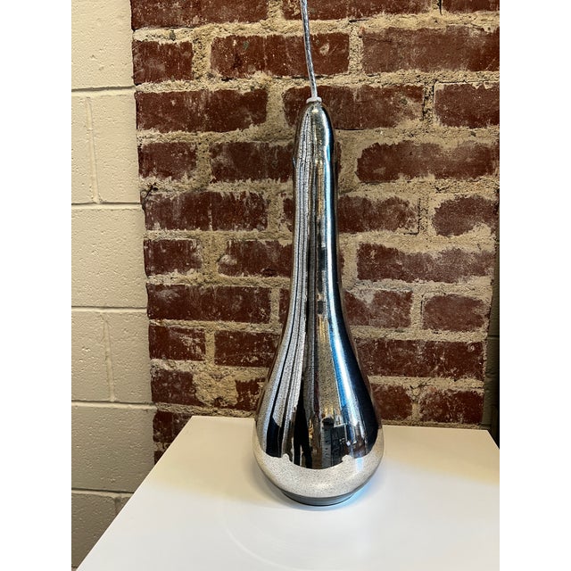 Pair of Antiqued Mirror/Mercury Glass Arianna pendants by Arteriors Home. Satin Nickel canopy (6" diam). About 28" of...