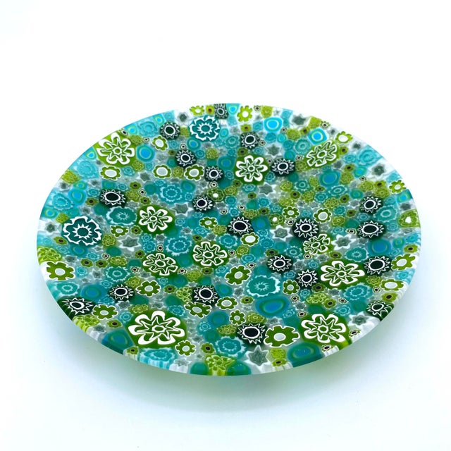This green Murano glass plate reflects nature-inspired beauty with green murrine. A unique and charming addition to your...