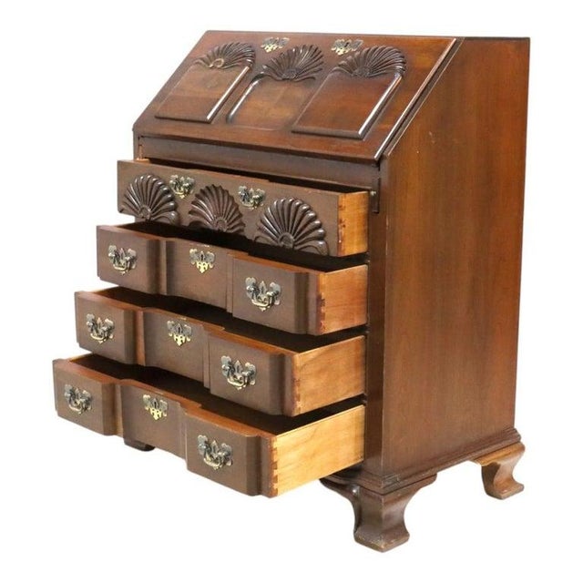 A Chippendale style secretary desk, crafted from mahogany, dating to approximately 1930, exemplifies the aesthetics of the...