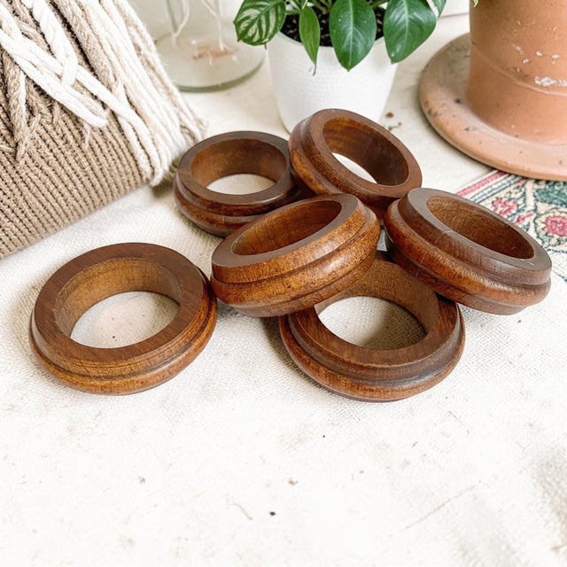 Elevate your dining experience with our Vintage MCM Teak Wood Napkin Rings, a stunning set of 6 that embodies the essence...