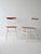 Set of 2 Scandinavian 60s chairs with shaped wooden seat and white painted wooden structure. The distinctive aspect of...