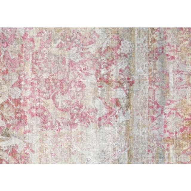 This Antique Indian Agra Rug, measuring 13'1" x 15'9", is handwoven in India’s Agra region. Known for their refined...