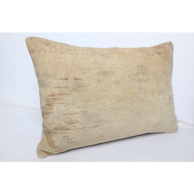 This handcrafted lumbar pillow cover is made from a vintage tribal Turkish Rug, showcasing a beautifully aged patina and...