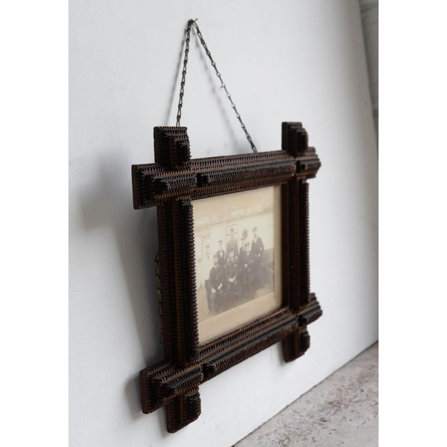 ANTIQUE FOLK ART CARVED PHOTO FRAME Typically notched hand-crafted tramp art picture frame of deep form. Charming original...