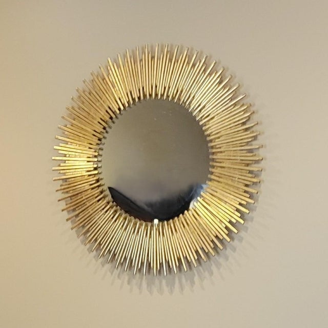 Make a bold statement with this dramatic round sunburst mirror. Measuring 30.25" in diameter and weighing approximately 30...